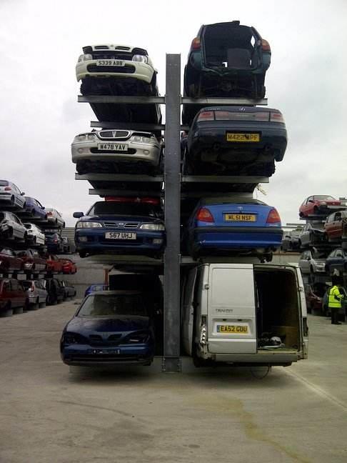 double sided cantilever racking at a scrap car yard. Cars stored on four levels