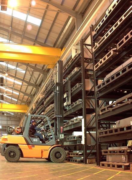 forklift truck loading heavy duty racks with tools